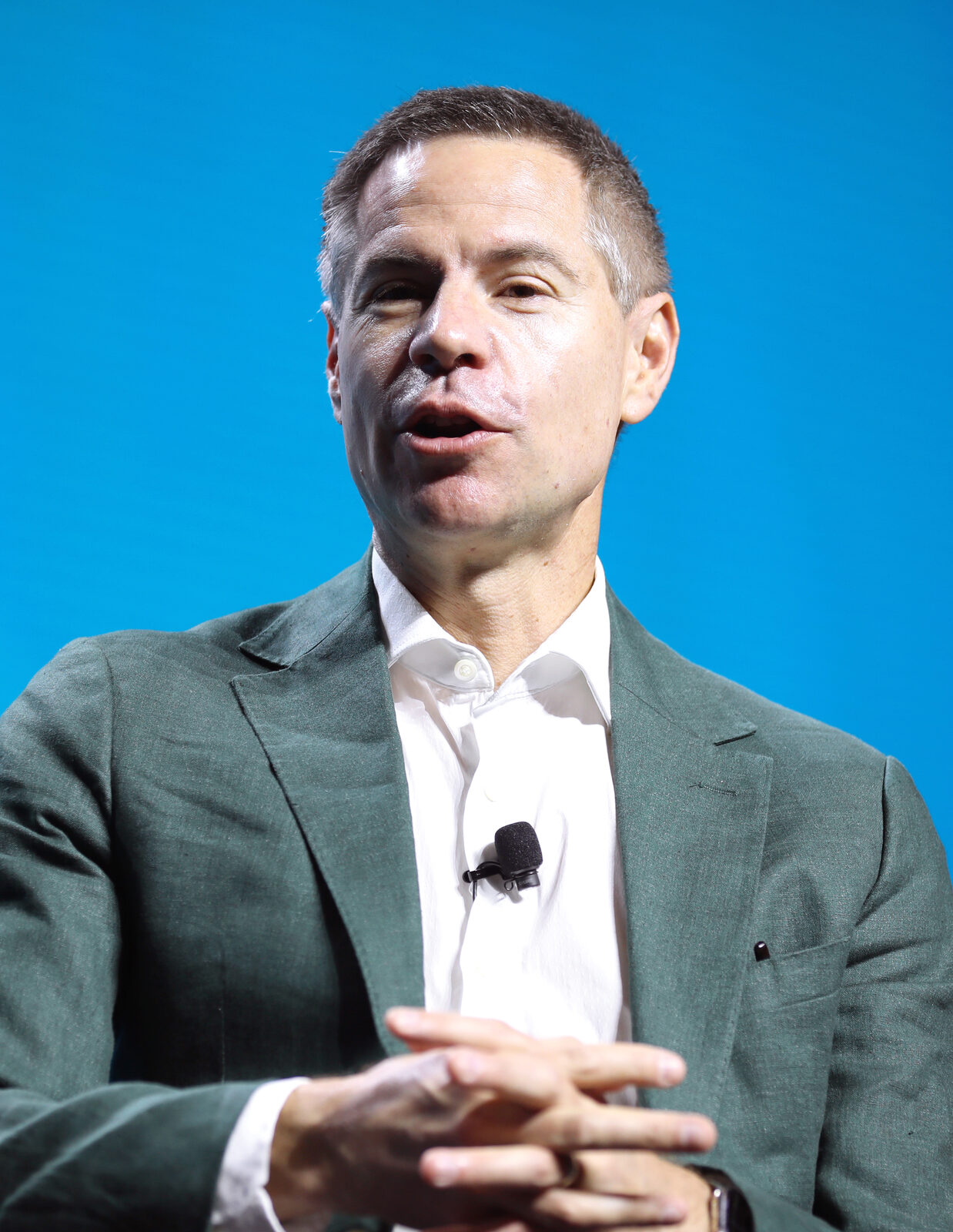 Michael Shellenberger speaking at a lectern with a microphone