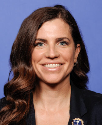 Official congressional portrait of Representative Nancy Mace, seated before a US flag