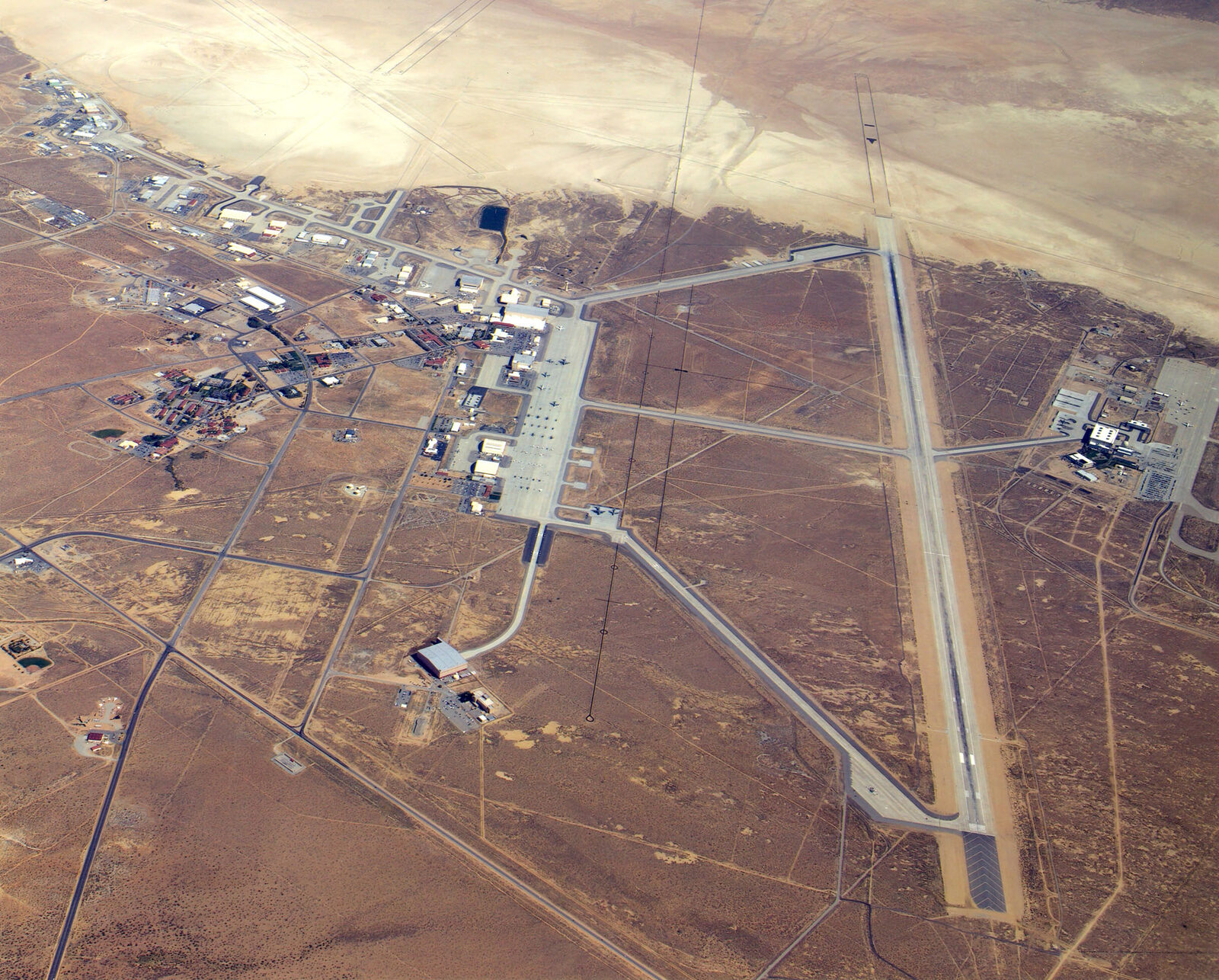 Aerial view of the main base area at Edwards Air Force Base, California, with runways and hangars on the desert floor