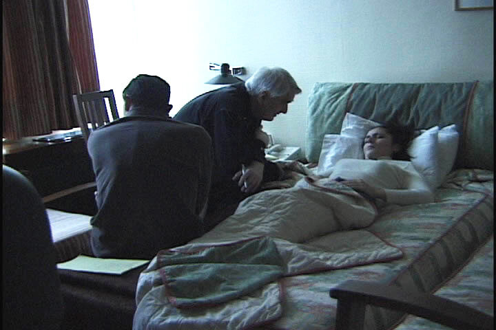 Two men seated beside a reclining woman during an interview session in a room in Istanbul, 1995