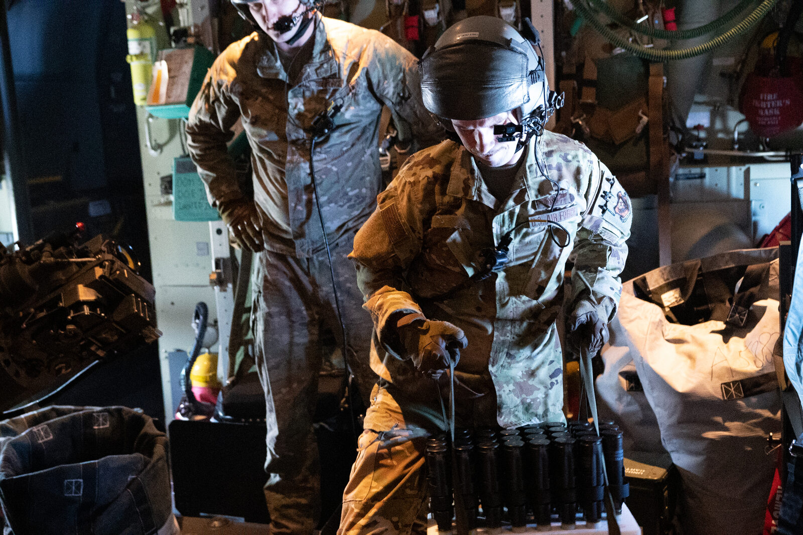 U.S. Air Force airmen reload the 30mm cannon aboard an AC-130J Ghostrider gunship during a live-fire training mission